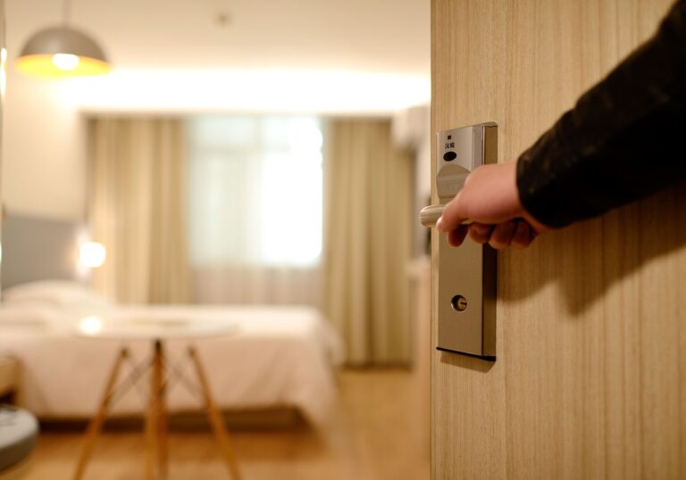 Hand on doorknob, preparing to enter hotel room